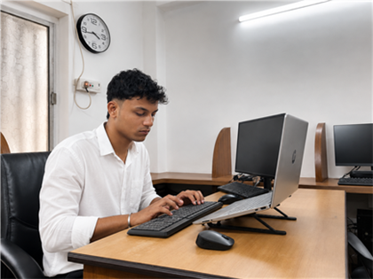 Infinite Option web developer coding at the office workstation